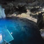 Wide view of the domed Devil's Den cavern and its clear blue spring water, Williston, Florida.